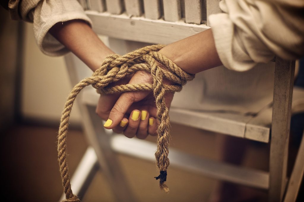Women in chair - bound with rope